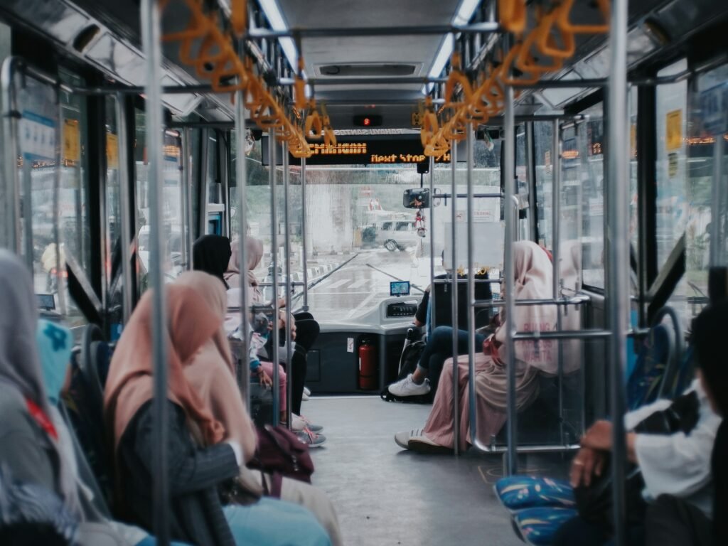 Women wearing hijab sitting inside a TransJakarta bus in Jakarta